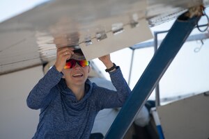 Student measuring glider flap angle with protractor