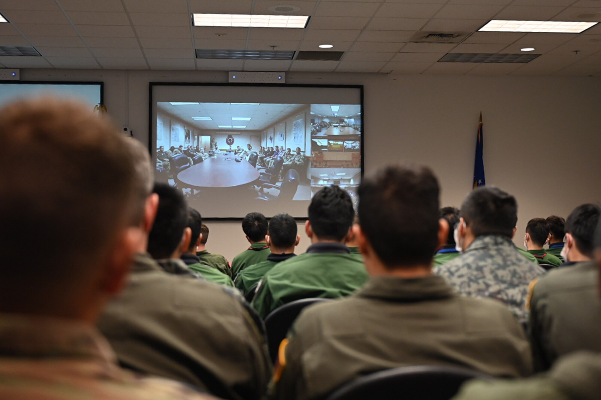 Service members from U.S. Air Force and Japan Self-Air Defense Force listen to the Deployed Forces Commander, Col. Brian Cusson, to kick-off RED FLAG-Alaska 21-2 at Joint Base Elmendorf-Richardson, Alaska, June 10, 2021.