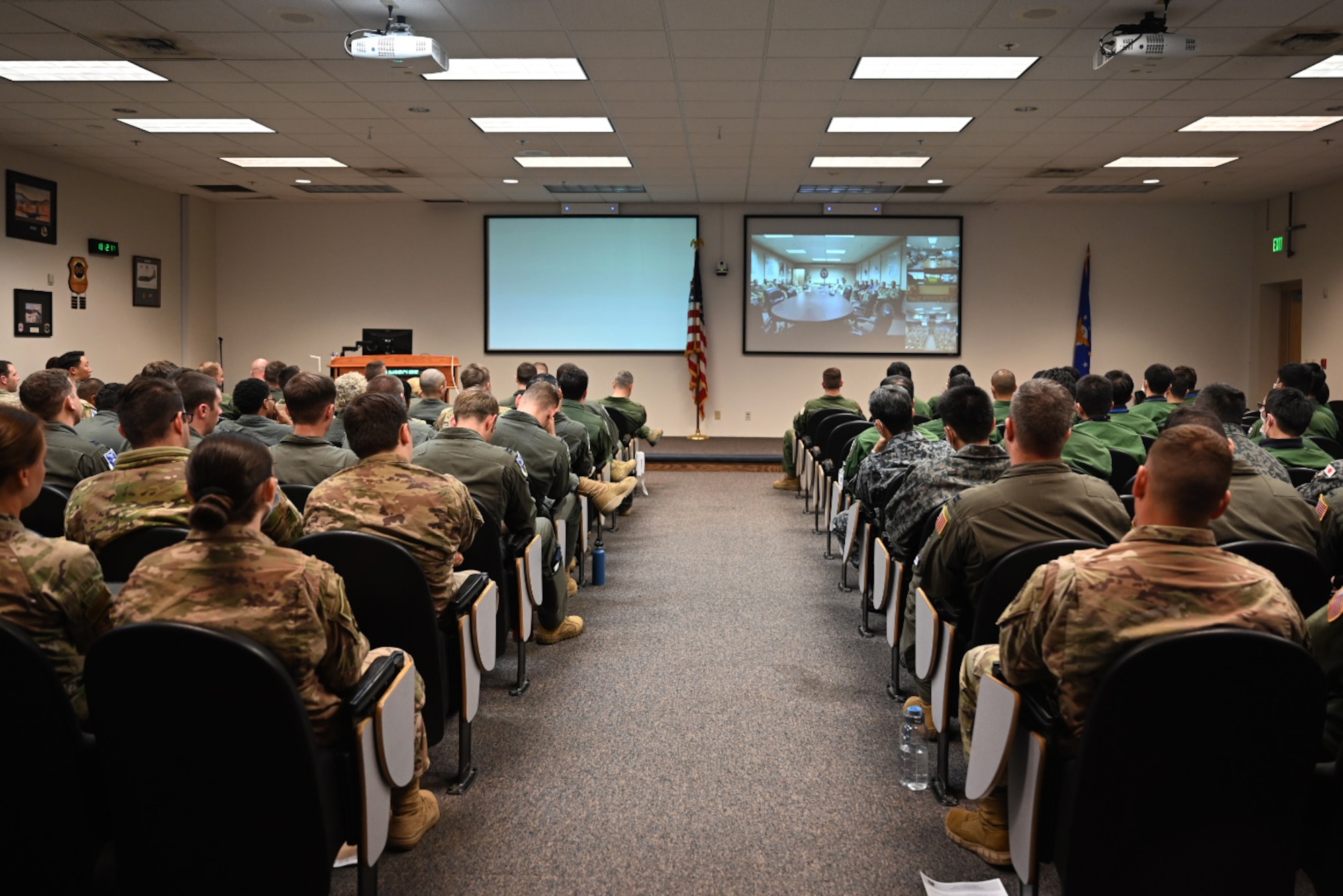 Service members from U.S. Air Force and Japan Self-Air Defense Force listen to the Deployed Forces Commander, Col. Brian Cusson, to kick-off RED FLAG-Alaska 21-2 at Joint Base Elmendorf-Richardson, Alaska, June 10, 2021.
