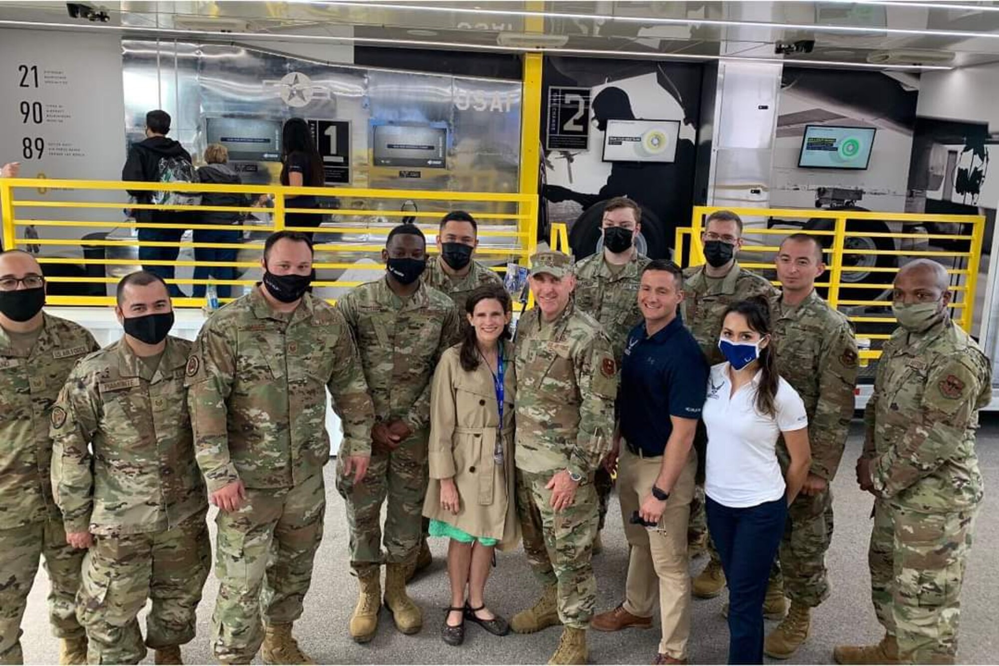 Dinah Thomas, center, with her husband, Maj. Gen. Ed Thomas, Jr., Air Force Recruiting Service commander, join recruiters for a group photo during a NASCAR recruiting event during Memorial Day weekend in May 2021.