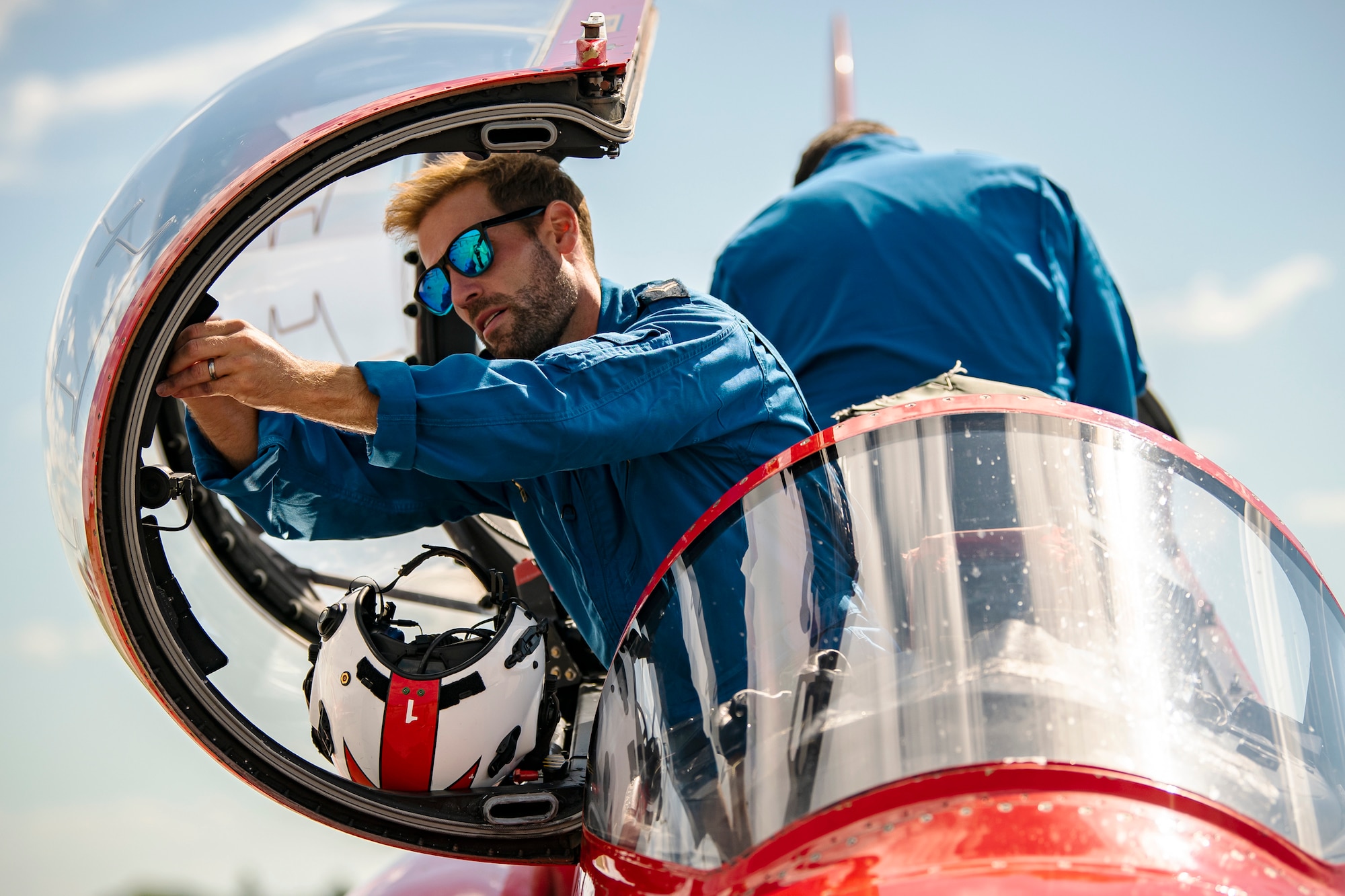 Corporal Steve Greenwood, Red Arrows mechanical engineer and dye team leader, performs maintenance on a Hawk T1 aircraft at RAF Fairford, England, June 4, 2021. The Red Arrows landed at Fairford to refuel in preparation for the Midlands Air Festival. (U.S. Air Force photo by Senior Airman Eugene Oliver)