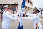 Cmdr. Jonathan Nieman, commanding officer of U.S. Naval Mobile Construction Battalion (NMCB) 3, passes the battalion colors.