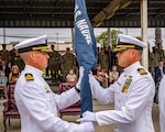 Cmdr. Ryan Carey (left) passes the battalion flag to Cmdr. Andrew Olsen.