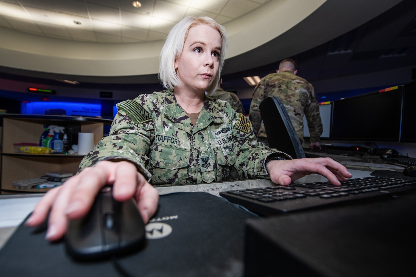 Navy member works on a computer.