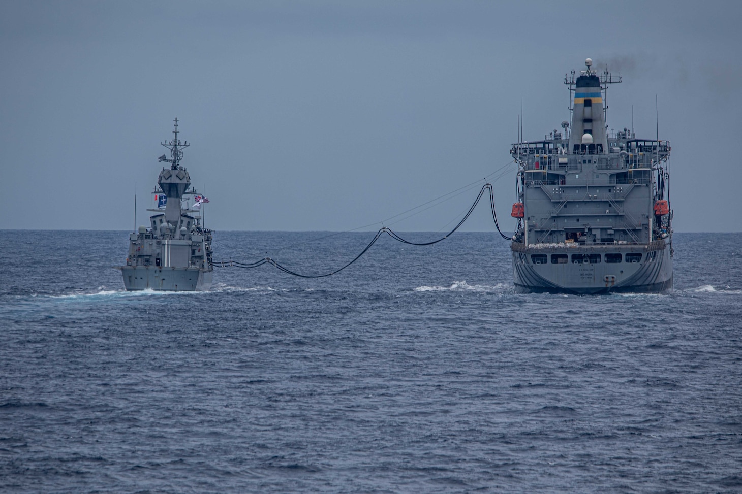 The Royal Australian Navy Anzac-class frigate HMAS Ballarat (FFH 155) steams ahead of Arleigh Burke-class guided-missile destroyer USS Curtis Wilbur (DDG 54) during a replenishment-at-sea with the Military Sealift Command Henry J. Kaiser Class fleet replenishment oiler USNS Big Horn (T-AO 198). Curtis Wilbur is assigned to Commander, Task Force 71/Destroyer Squadron (DESRON) 15, the Navy’s largest forward-deployed DESRON and U.S. 7th Fleet’s principal surface force.