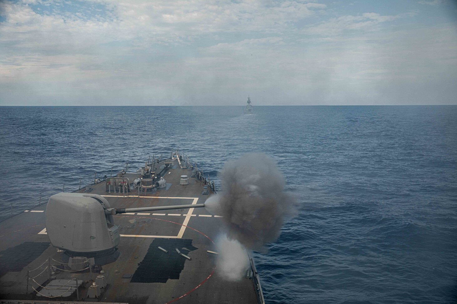 The Royal Australian Navy Anzac-class frigate HMAS Ballarat (FFH 155) steams ahead of Arleigh Burke-class guided-missile destroyer USS Curtis Wilbur (DDG 54) during a joint live-fire exercise. Curtis Wilbur is assigned to Commander, Task Force 71/Destroyer Squadron (DESRON) 15, the Navy’s largest forward-deployed DESRON and U.S. 7th Fleet’s principal surface force.