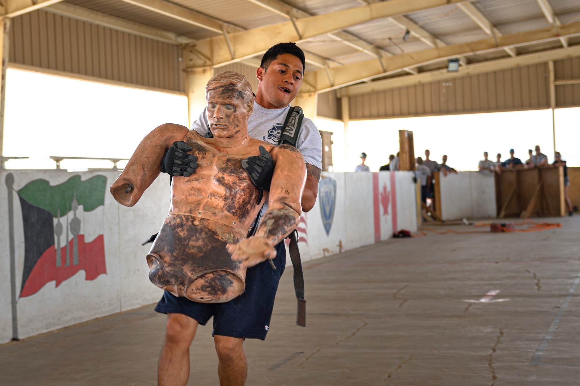 A photo of an Airman carrying a simulated victim