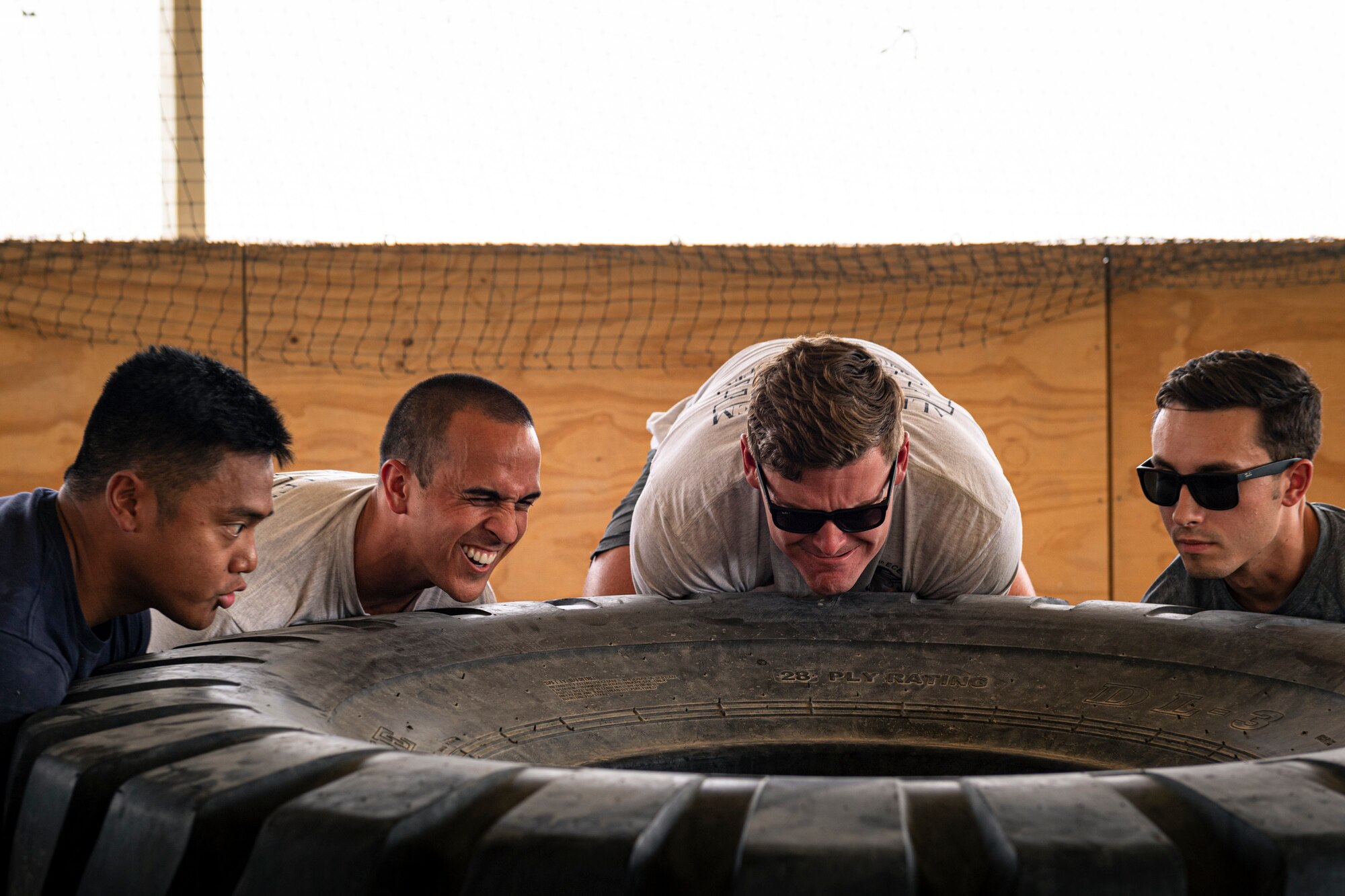 A photo of Airmen lifting a tire