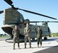 (Left to right) Spanish Army Sgt. 1st Class Javier Navarro-Blasco, CH-47 helicopter repairer; U.S. Army Sgt. 1st Class David Boyles, Aircraft Maintenance Instructor with the Eastern Army National Guard Aviation Training Site; and Spanish Army Sgt. 1st Class Lorena Monge Prieto, CH-47 helicopter repairer, pose for a photo in front of a CH-47F Chinook at Fort Indiantown Gap, Pa.