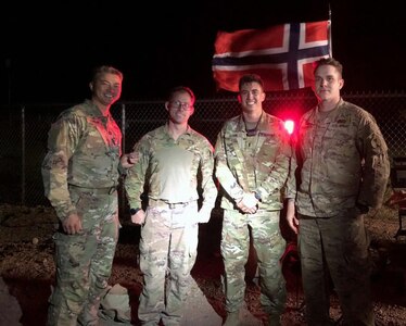 Capt. Laudy Choum, communications officer with the 898th Brigade Engineer Battalion, poses with other members of the Washington National Guard after completing the Norwegian Foot March in Ellensburg, Wash., June 5, 2021. Participants must march 18.6 miles within 4 hours, 30 minutes while in uniform and boots carrying a 25-pound rucksack.