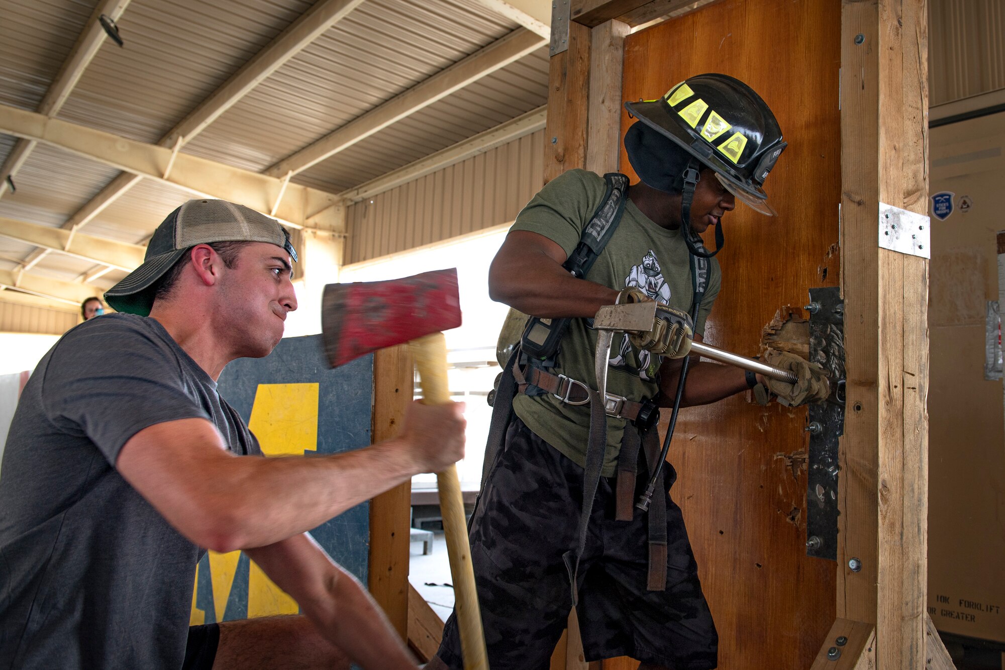 A photo of Airmen breaching a door