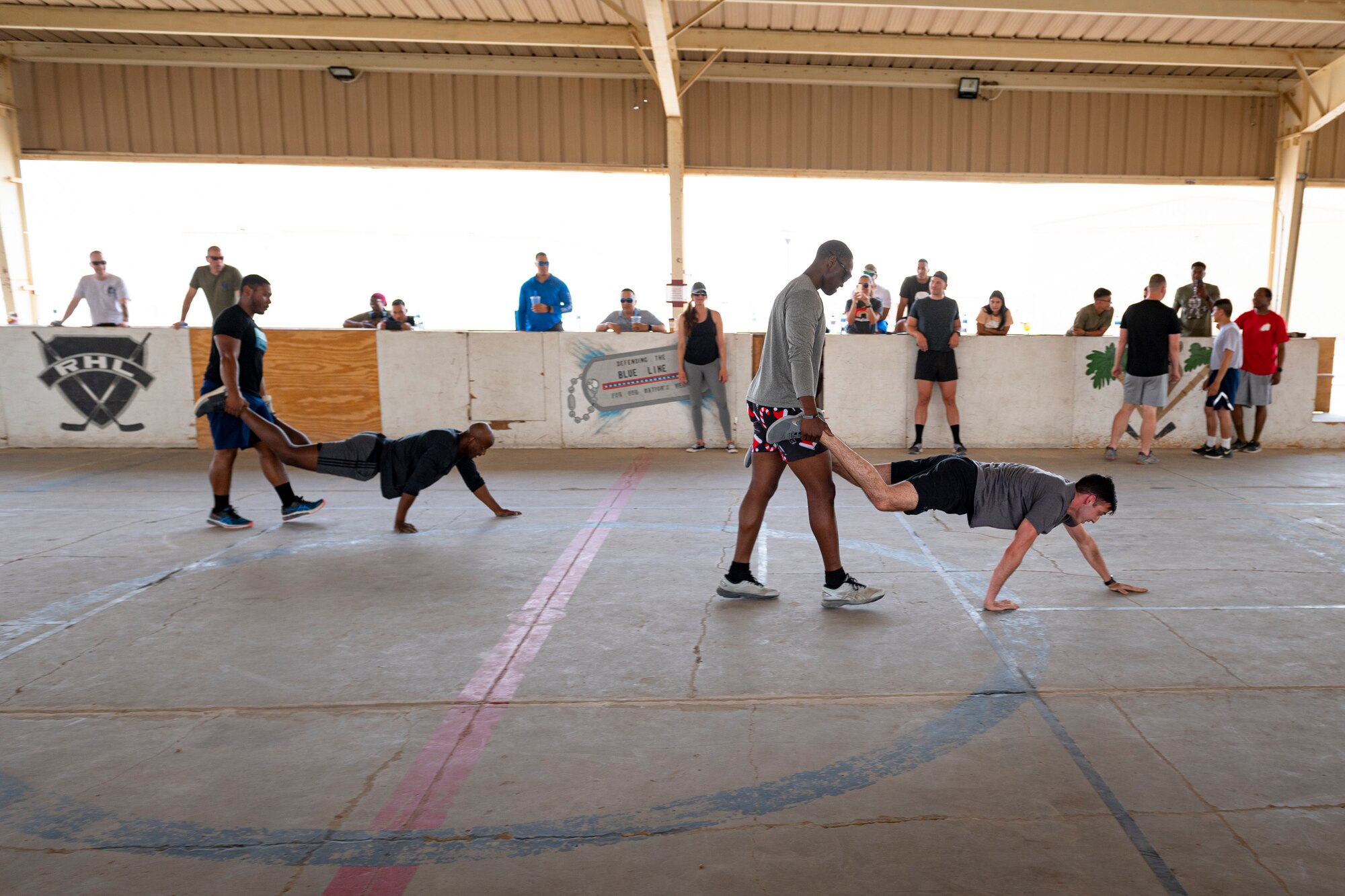 A photo of Airmen performing wheelbarrow exercises