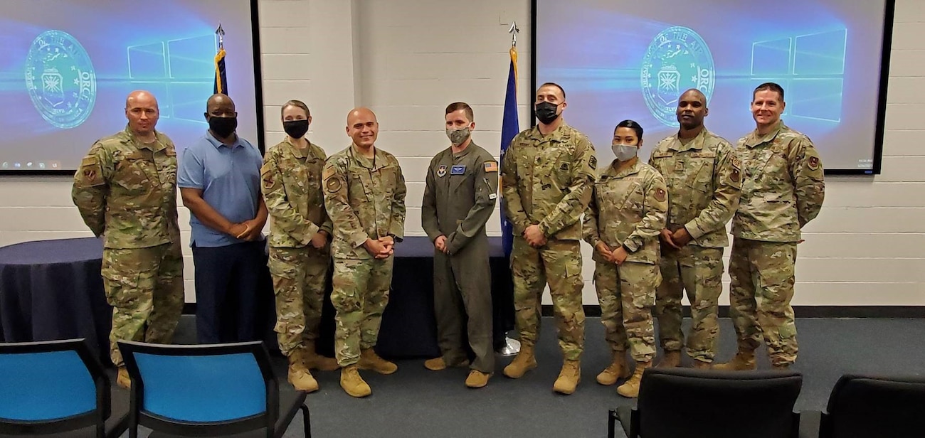 Instructors and leadership gather for group photo at ceremony.