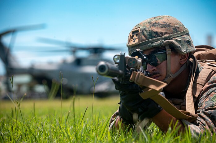 A U.S. Marine with Maritime Raid Force, 31st Marine Expeditionary Unit, holds security after fast roping off of a CH-53E Super Stallion on Camp Hansen, Okinawa, Japan, June 3, 2021. The Marines train to fast rope in case they are required to depart from the aircraft in a timely manner or a possible landing in uneven terrain. The 31st MEU, the Marine Corps’ only continuously forward-deployed MEU, provides a flexible and lethal force ready to perform a wide range of military operations as the premier crisis response force in the Indo-Pacific region.