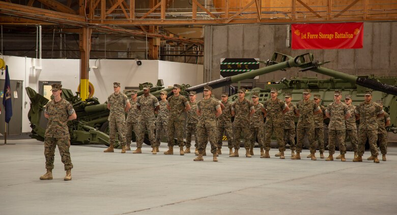 Marines 1st Force Storage Battalion and Marine Corps Logistics Base Barstow stand in formation awaiting the commencement of the 1st FSB Change of Command held on the Yermo Annex aboard MCLB Barstow, California, June 8. The ceremony transitioned leadership of 1st FSB from Lt. Col. Micheal Graham to incoming Lt. Col. LaBarron McBride.