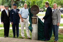 An Air Transportation medallion bust is revealed during a commemoration ceremony for the Air Transportation career field, and retired U.S. Air Force Col. Lawrence Lane, former security forces raven officer, on Scott Air Force Base, Illinois, June 08, 2021. The Air Transportation medallion bust honors the deaths of fallen Airmen belonging to the Air Transportation career field, and made from the debris of the World Trade Center after 9/11. (U.S. Air Force Photo by Airman 1st Class Isaac Olivera)