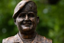 Retired U.S. Air Force Col. Lawrence Lane, former security forces raven officer, sculpture bust is revealed during a commemoration ceremony, on Scott Air Force Base, Illinois, June 08, 2021. Lane created the Phoenix Raven program, and then graduated as the first Raven Training Class in February 1997. (U.S. Air Force Photo by Airman 1st Class Isaac Olivera)
