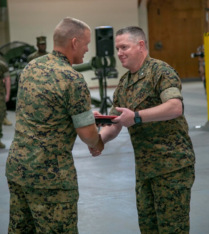 LtCol. Micheal Graham, outgoing commanding officer, 1st Force Storage Battalion, is presented the Legion of Merit (second award) by Col. Kipp Walgren, commanding officer, Marine Force Storage Command, during a change of command ceremony held aboard Marine Corps Logistics Base Barstow, California, June 8.
