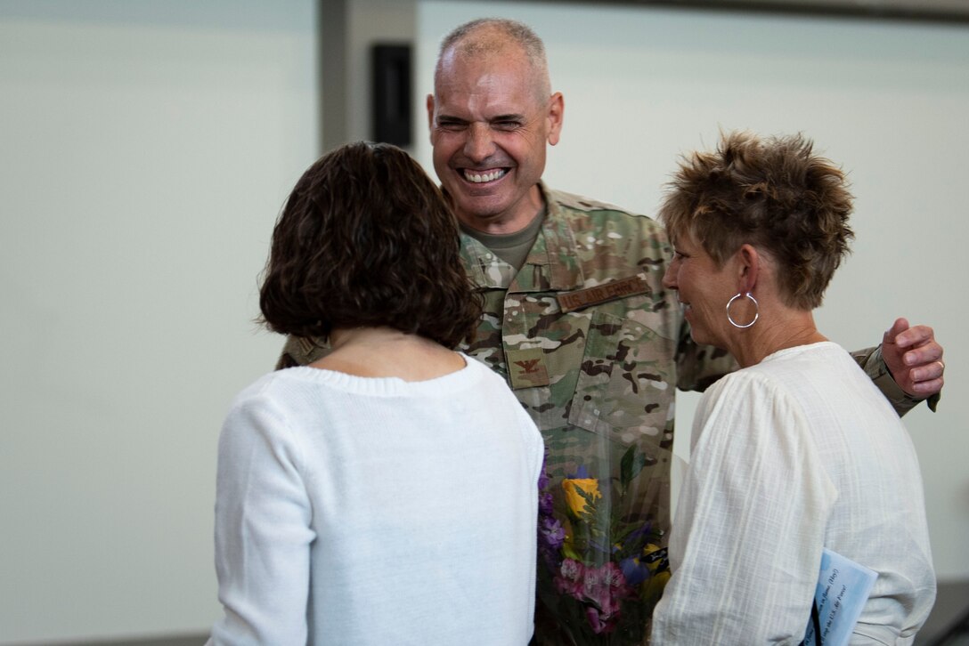 A photo of a commander greeting his family.