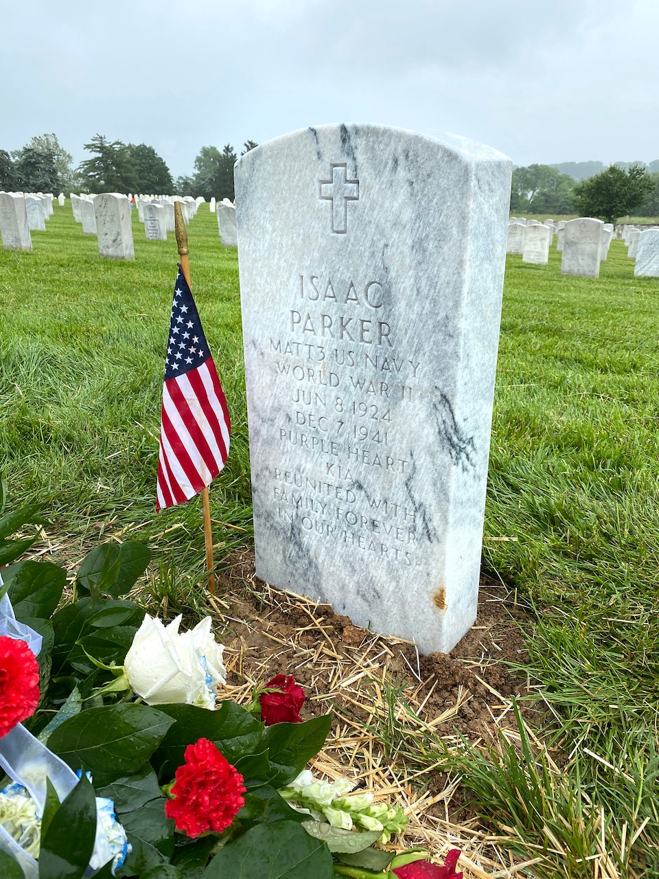 A marble headstone marks the final resting place of Navy Mess Attendant 3rd Class Isaac Parker at Jefferson Barracks National Cemetery in St. Louis, MO. Parker was killed aboard the USS Oklahoma (BB-37) when it received up to eight torpedo hits and capsized in less than 12 minutes during the attack on Pearl Harbor, HI, December 7, 1941. His remains were positively identified by the Defense POW/MIA Accounting Agency in 2020 and he was reunited with his father, mother and six other relatives also buried at the cemetery on June 8, 2021, 79 years after his death. (U.S. Navy photo by Commander Kris Hooper)
