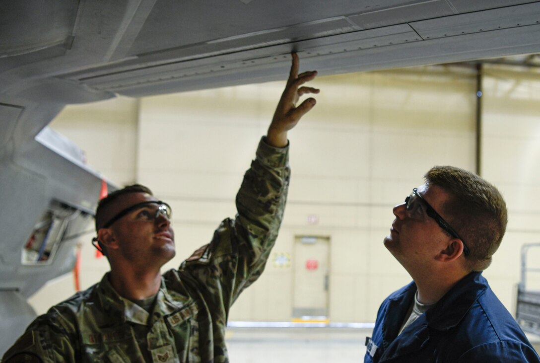 Staff Sgt. Robert Briones, 62nd Aircraft Maintenance Unit crew chief, and Airman 1st Class Todd Combe, 61st AMU crew chief, inspect an outer mold line on the wing of an F-35A Lightning II aircraft June 4, 2021, at Luke Air Force Base, Arizona. Maintenance Airmen conduct OML inspections to track any exterior damage on the aircraft before and after flight; the OML inspection is one of the techniques taught within the Lightning Technician Program. The efforts of LTP cost-effectively modernizes Luke’s F-35 maintenance operations as a whole by creating multi-capable Airmen. (U.S. Air Force photo by Airman 1st Class David C. Busby)