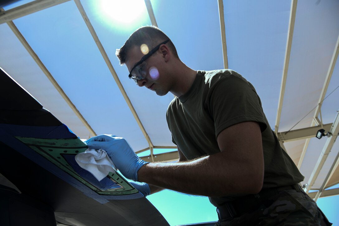 Senior Airman Harrison Reiter, 62nd Aircraft Maintenance Unit crew chief, cleans the wing tip lens on an F-35A Lightning II aircraft as per his training with the Lightning Technician Program June 4, 2021, at Luke Air Force Base, Arizona. Keeping the wing tip lens clean and serviceable is one of the tasks necessary to maintain an aircraft. Sharing new information between units through the LTP cultivates an environment of excellence throughout the 56th Maintenance Group by creating and empowering multi-capable Airmen. (U.S. Air Force photo by Airman 1st Class David C. Busby)
