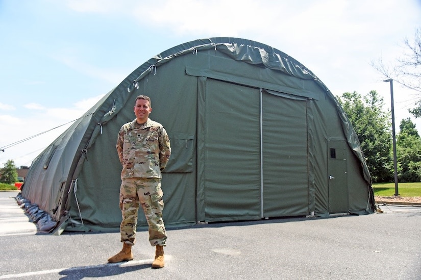 U.S. Air Force Lt. Col. David Jarnot, 87th Medical Support Squadron commander, poses for a picture in front of a Californian tent, outside the 87th Medical Group facility, June 9th, 2021, on Joint Base McGuire-Dix-Lakehurst, N.J. With a combination of 67,000 man hours during a period of 14 months, Jarnot led his team in performing over 17,000 tests for COVID-19 patients outside the 87th MDG facility to prevent the spread of COVID-19. (U.S. Air Force photo by Daniel Barney)