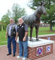 two veterans standing by blackjack statue