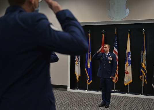 Members of the 313th Training Squadron salute U.S. Air Force Lt. Col. Daniel Blackledge, incoming 313th Training Squadron commander, during the change of command ceremony at the Event Center on Goodfellow Air Force Base, Texas, June 11, 2021. The salute represents the squadron welcoming their new commander. (U.S. Air Force photo by Senior Airman Ashley Thrash)