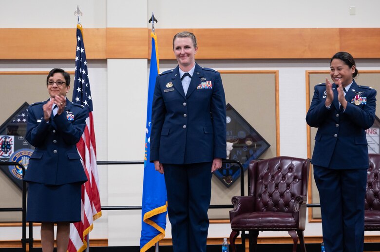 Col. Lisa Martinez, left, 341st Mission Support Group commander, and Maj. Kristina Eclevia, right, 341st Force Support Squadron outgoing commander, clap for Lt. Col. Corrie Pecoraro, center, 341st FSS incoming commander during a change of command ceremony June 11, 2021, at Malmstrom Air Force Base, Mont.