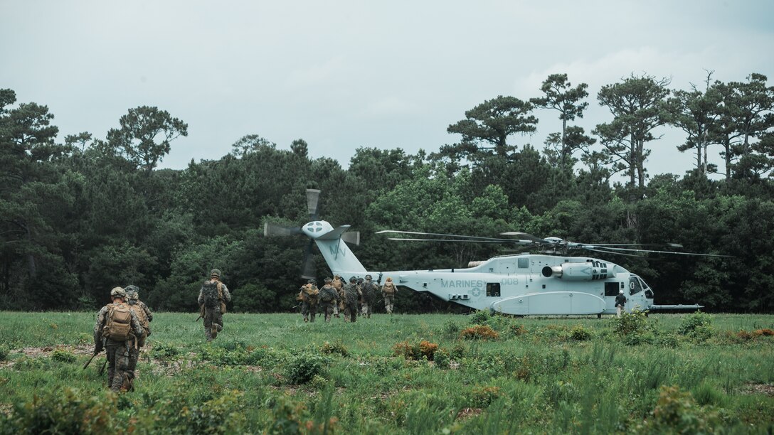 U.S. Marines with Alpha Company, 1st Battalion, 2d Marine Regiment (1/2), 2d Marine Division (MARDIV) sprint to a CH-53K King Stallion in Camp Lejeune, N.C., June 10, 2021. Marines with Alpha Company, 1st Battalion, 2d Marine Regiment, 2d Marine Division, executed an air assault operation in support of VMX-1 to test the capabilities of the CH-53K King Stallion, the U.S. Marine Corps’ newest heavylift helicopter. (U.S. Marine Corps photo by Cpl. Patrick King)