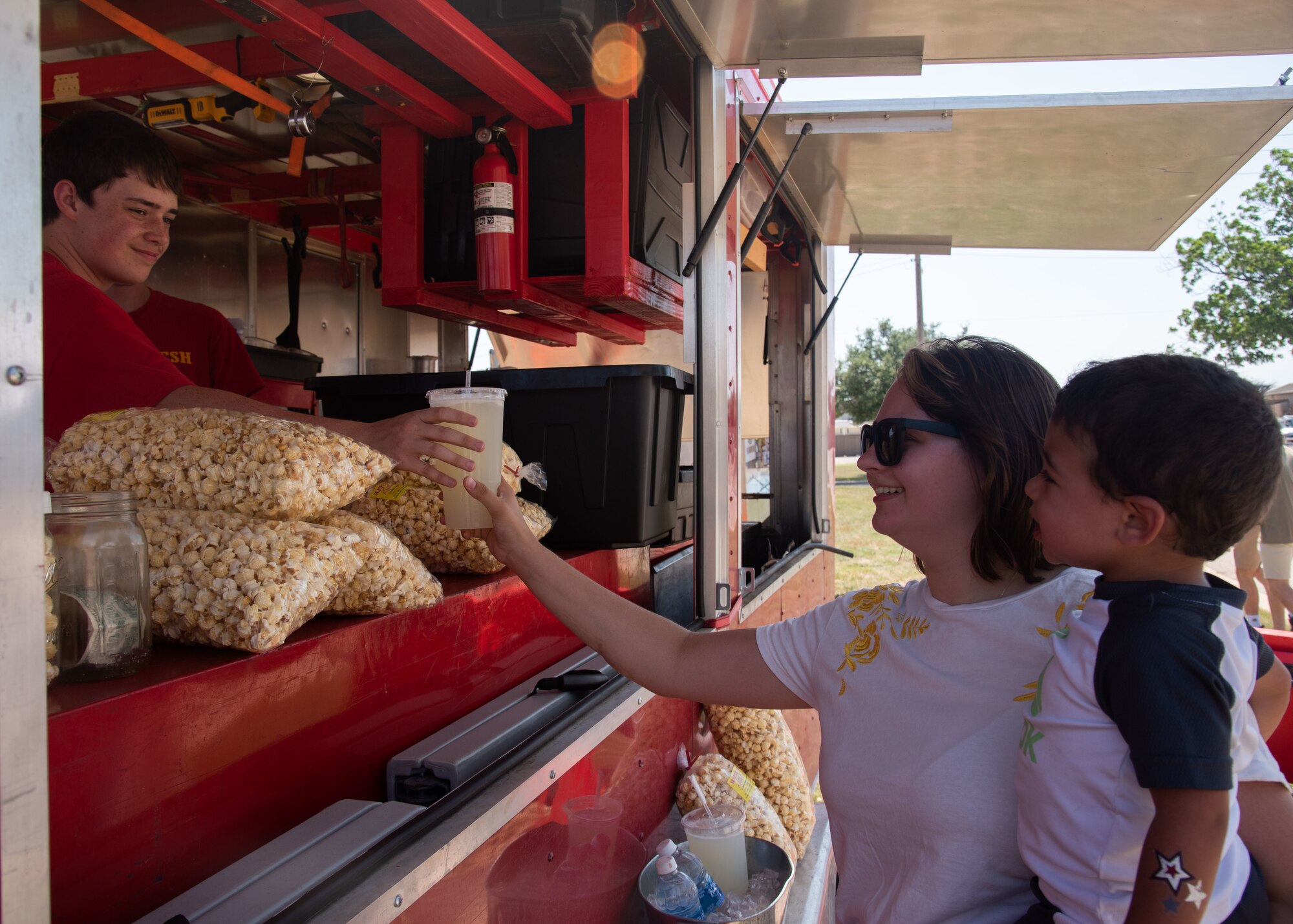 A Goodfellow Air Force Base member buys a drink from a food truck at the Event Center during the 17th Force Support Squadron Block Party, on Goodfellow AFB, Texas, June 11. Over 350 base members were in attendance for the 17th FSS Wing Day of Thank Black Party (U.S. Air Force photo by Staff Sgt. Tyrell Hall)