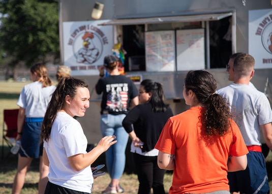 Goodfellow Air Force Base members stand in line at a food truck during the 17th Force Support Squadron Block Party, on Goodfellow AFB, Texas, June 11. Various food trucks attended the Block Party, providing food to more than 350 members in attendance. (U.S. Air Force photo by Staff Sgt. Tyrell Hall)