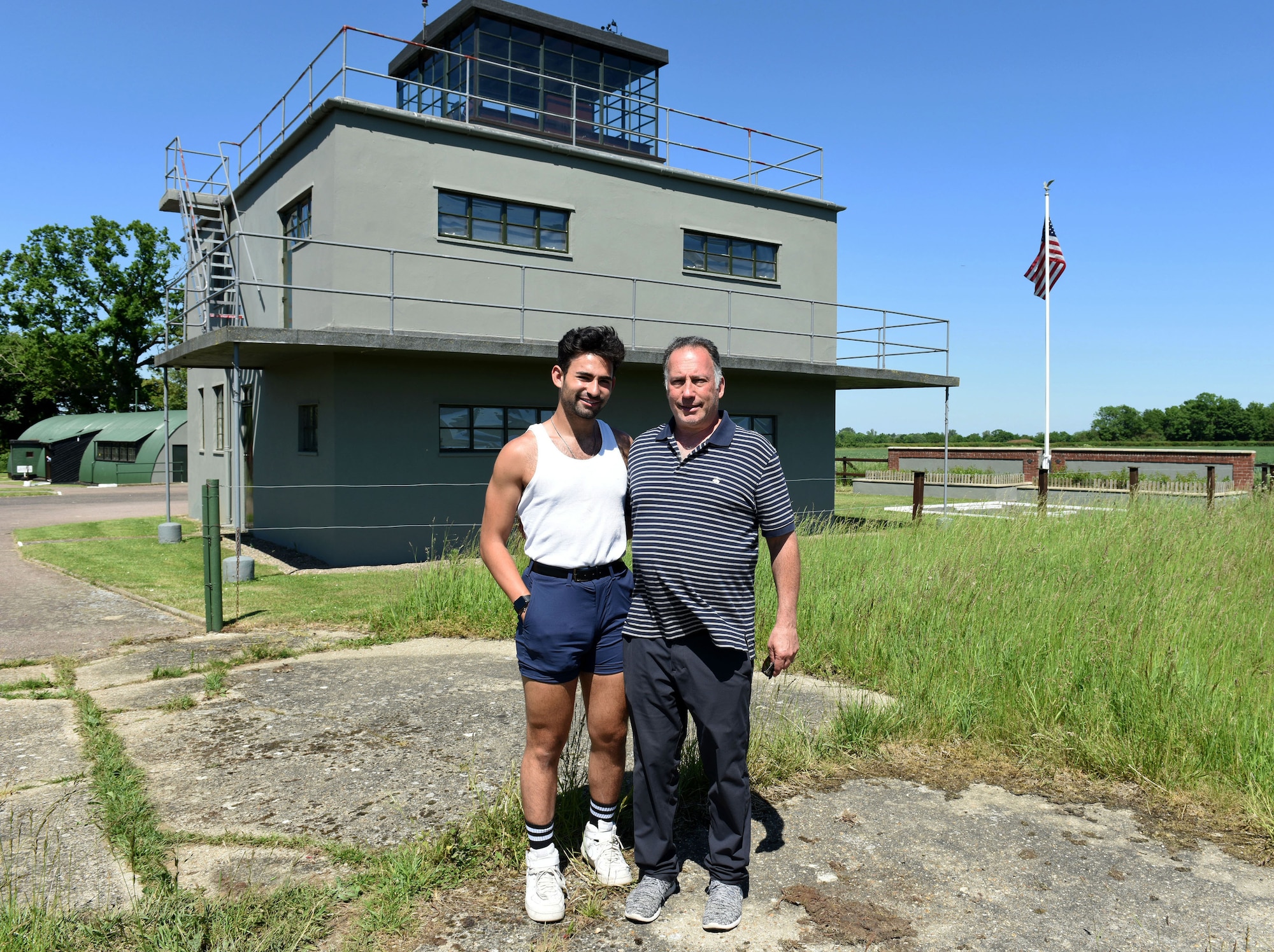 Sam and Dan Rosenthal, grandson and son of Lt. Col. Robert “Rosie” Rosenthal, pose for a photo in front of the control tower at the 100th Bomb Group Memorial Museum, Thorpe Abbotts, Diss, England, June 9, 2021. Rosie Rosenthal was a former pilot assigned to the 418th Bomb Squadron, 100th Bombardment Group, from September 1943 to September 1944 and flew 52 missions rather than the average 25. Dan and Sam visited England to attend the nose art dedication ceremony for “Rosie’s Riveters” at Royal Air Force Mildenhall, which honors their father and grandfather who passed away in 2007. (U.S. Air Force photo by Karen Abeyasekere)