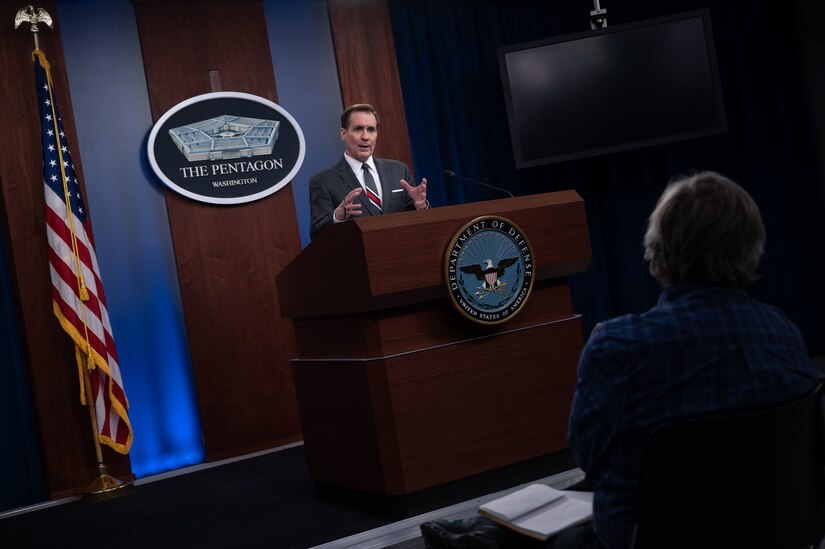 A man at a lectern speaks. A plaque on the wall behind him indicates that he is at the Pentagon.