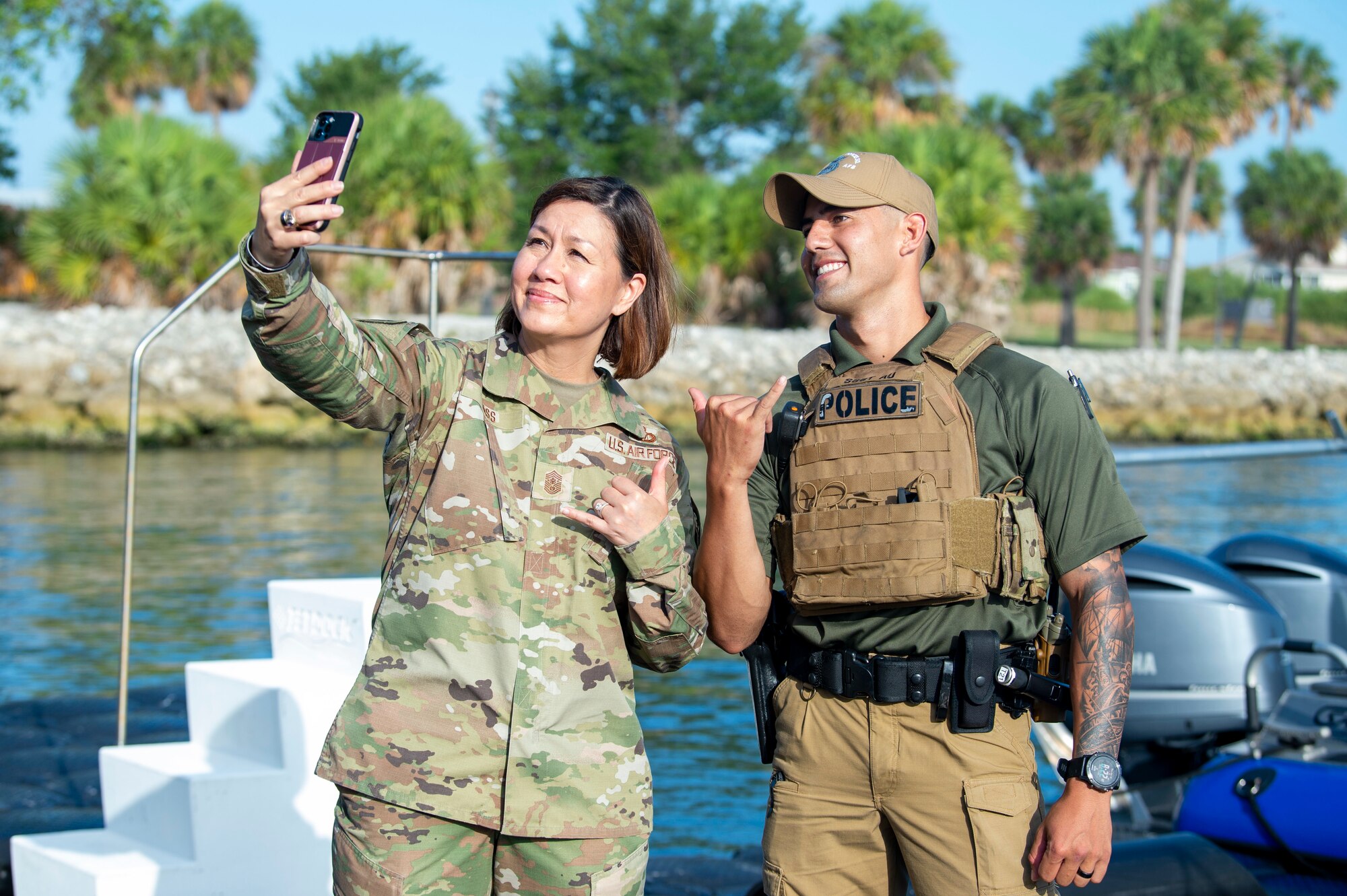 Chief Master Sgt. of the Air Force JoAnne S. Bass poses for a photo with U.S. Air Force Staff Sgt. William Au, a 6th Security Forces Squadron (SFS) marine patrolman, at MacDill Air Force Base, June 10, 2021.