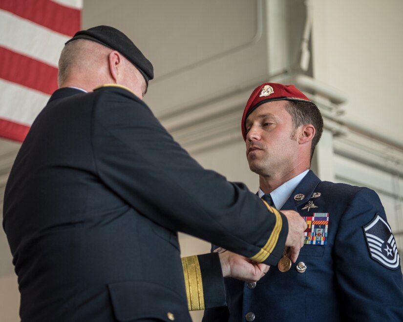 Brig. Gen. Hal Lamberton (left), the adjutant general for the Commonwealth of Kentucky, pins the Airman’s Medal to the uniform of Master Sgt. Daniel Keller, a combat controller in the 123rd Special Tactics Squadron, during a ceremony at the Kentucky Air National Guard Base in Louisville, Ky., June 12, 2021. Keller earned the award for heroism in recognition of his actions to save human life following a traffic accident near Louisville in 2018. (U.S. Air National Guard photo by Tech. Sgt. Joshua Horton)