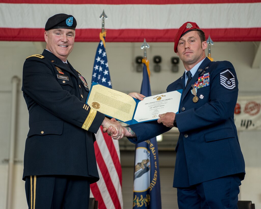 Brig. Gen. Hal Lamberton (left), the adjutant general for the Commonwealth of Kentucky, presents the Airman’s Medal to Master Sgt. Daniel Keller, a combat controller in the 123rd Special Tactics Squadron, during a ceremony at the Kentucky Air National Guard Base in Louisville, Ky., June 12, 2021. Keller earned the award for heroism in recognition of his actions to save human life following a traffic accident near Louisville in 2018. (U.S. Air National Guard photo by Tech. Sgt. Joshua Horton)