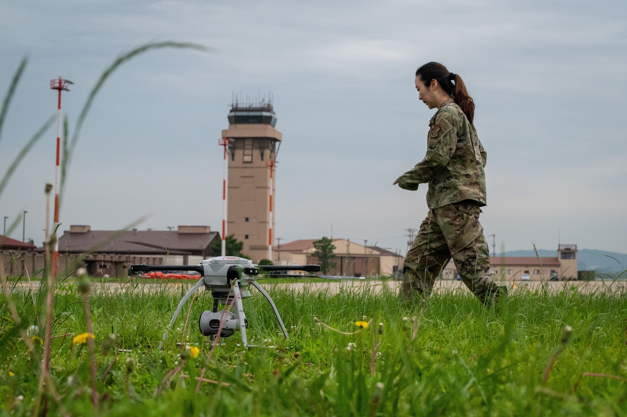 Senior Airman Clara Song, 51st Civil Engineer Squadron construction inspector, inspects small unmanned aircraft systems after landing at Osan Air Base, Republic of Korea, June 6, 2021. As a SUAS operator, Song must be proficient with operating the Aeryon SkyRanger system. (U.S. Air Force photo by Tech. Sgt. Nicholas Alder)