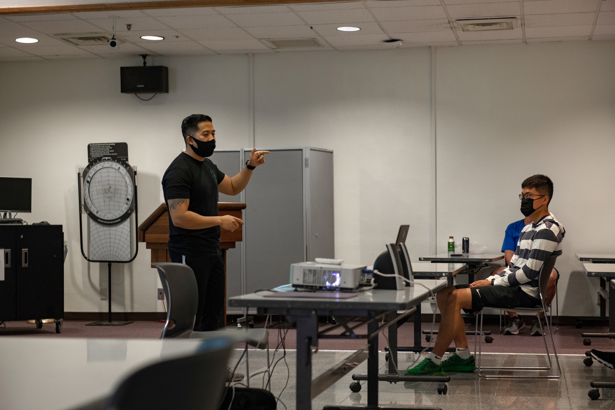 A facilitator stands in front of the class and discusses resiliency strategies with the Airmen in the course.