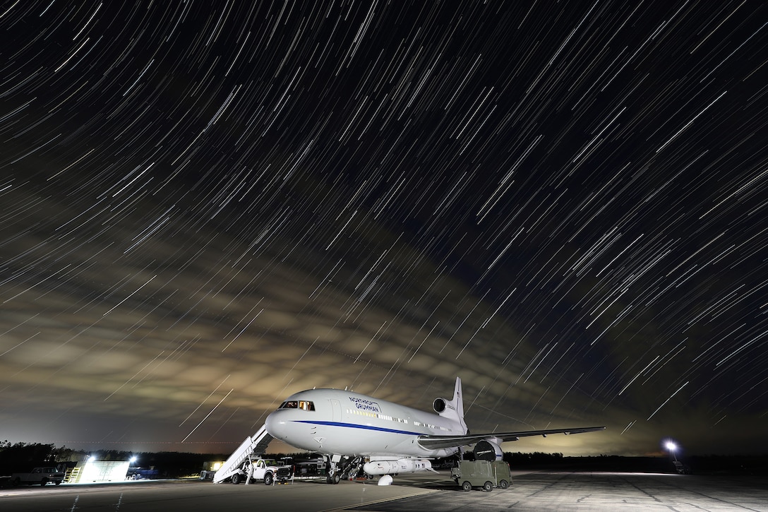 A parked plane at night.