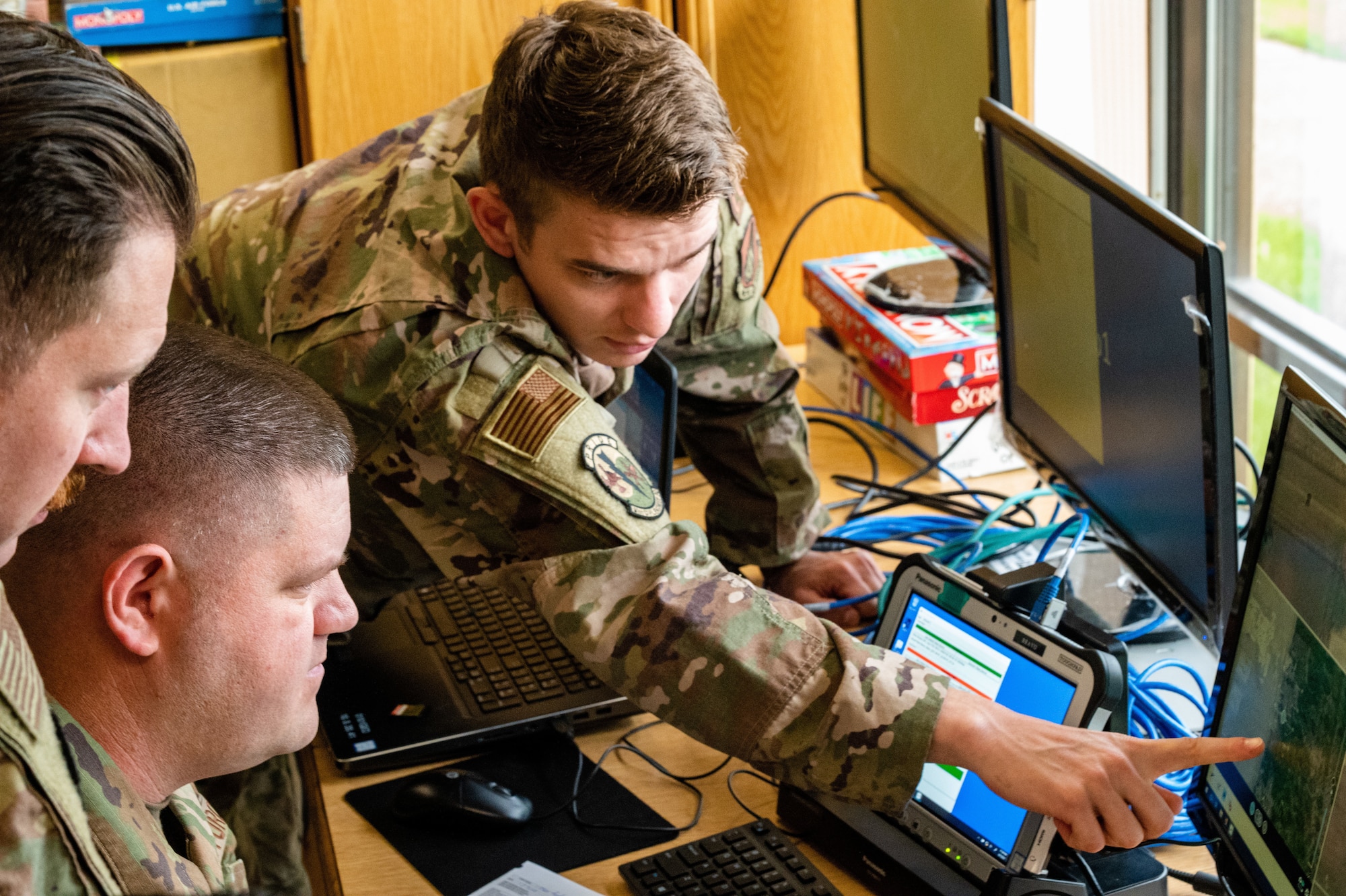 Senior Airman Austin Duck, 51st Civil Engineer Squadron explosives ordnance disposal technician, points out a training marker on the video feed of a small unmanned aircraft system at Osan Air Base, Republic of Korea, June 6, 2021. The operators perform aerial assessments of the airfield, as part of the Rapid Airfield Damage Assessment System. (U.S. Air Force photo by Tech. Sgt. Nicholas Alder)
