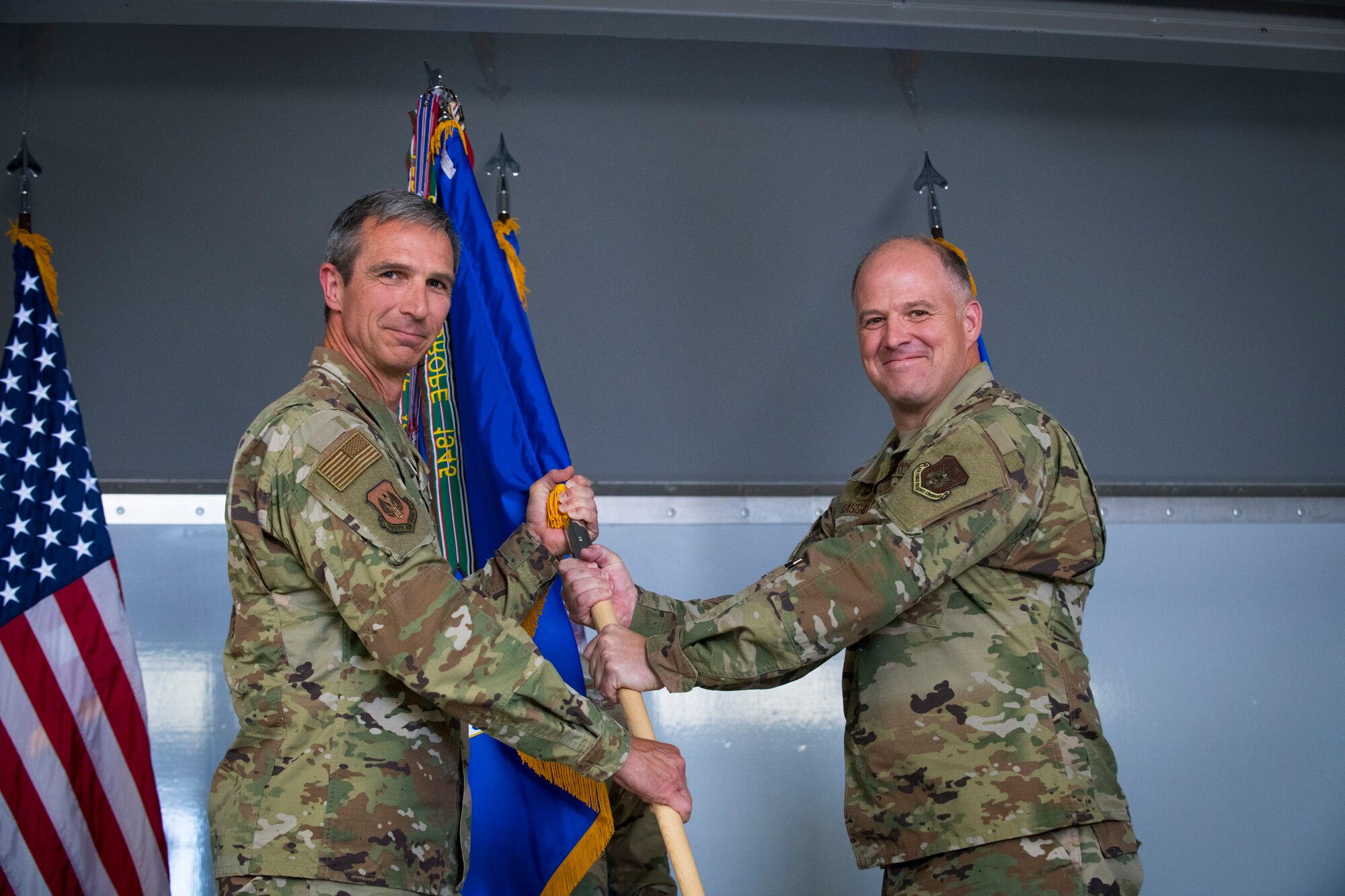 Maj. Gen. Bryan Radliff, 10th Air Force commander, passes the 926th Wing guidon to Col. Sean Rassas, the incoming 926th Wing commander during a change of command ceremony, June 13, 2021, at Nellis Air Force Base, Nevada. Rassis was previously assigned to the 944th Fighter Wing serving as the vice commander. (U.S. Air Force photo by Senior Airman Brett Clashman)