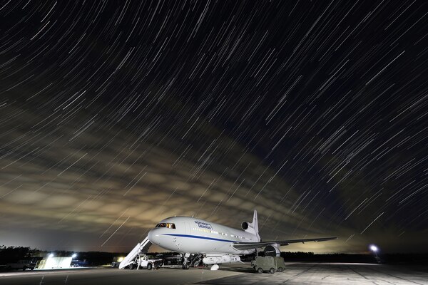 A parked plane at night.