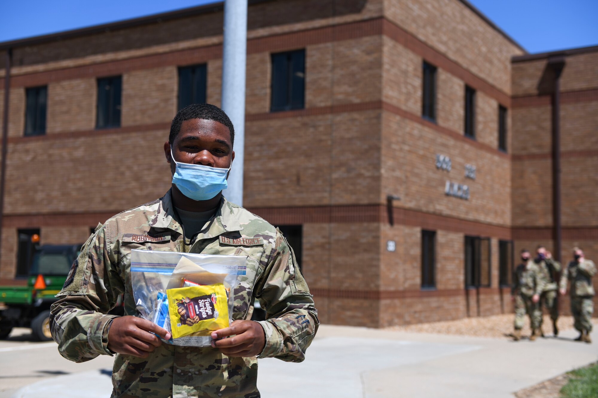 Airman 1st Class Jalen Robinson, 509th Aircraft Maintenance Squadron weapons load crew member, shows off his snack pack, at Whiteman Air Force Base, Missouri, May 5, 2021. The 509th AMXS Whiteman Base Community Council Concordia, Missouri, liaison delivered the snacks to support the Airmen through an exercise. (U.S. Air Force photo by Staff Sgt. Sadie Colbert)