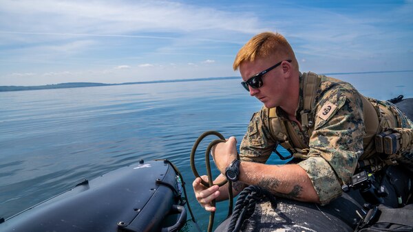 U.S. Marine Corps explosive ordnance disposal technicians release an unmanned service vehicle used for sea floor mapping and mine hunting.