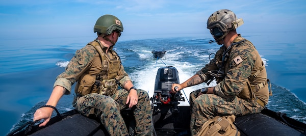U.S. Marine Corps explosive ordnance disposal technicians release an unmanned service vehicle used for sea floor mapping and mine hunting.
