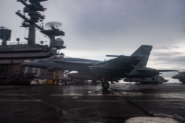 An F/A-18E Super Hornet attached to the Eagles of Strike Fighter Squadron (VFA) 115 lands on the flight deck.