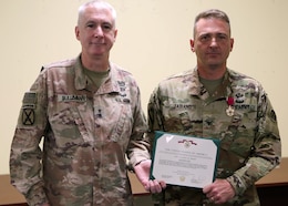 Commanding General of 1st Theater Sustainment Command, Maj. Gen. John P. Sullivan, poses with Area Support Group-Qatar Commander, Col. Stephen A. Fabiano after the general presented Fabriano with the Legion of Merit at the June 10, 2021 end of mission at Camp As Sayliyah, Qatar. The Army established ASG-Qatar in 1992, and for the last three decades, the military and civilian personnel deployed there supported military and humanitarian operations in the region. The ASG-Qatar merged with ASG-Jordan as part of the Army's ongoing realignment of assets and personnel. (U.S. Army photo by David Gomes)