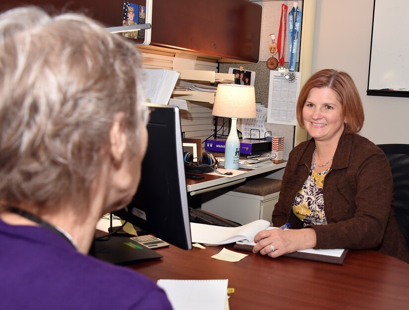 Kim Dankulich, right, deputy director of the Force Projection Directorate at the U.S. Army Medical Materiel Agency, talks with a coworker June 9 at Fort Detrick, Maryland.